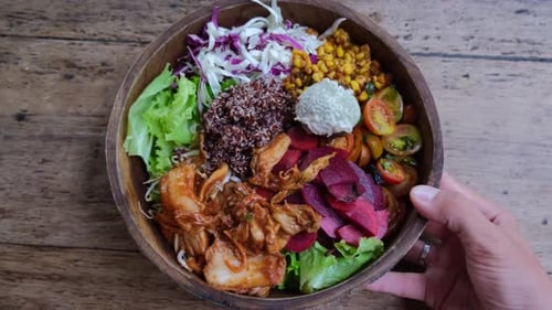 Vibrant Bowl of Vegetables on Rustic Wooden Table