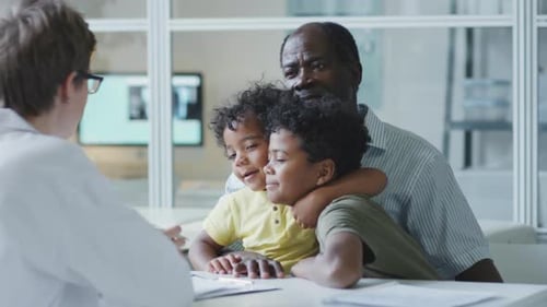 Father of Two Boys Speaking with Pediatrician