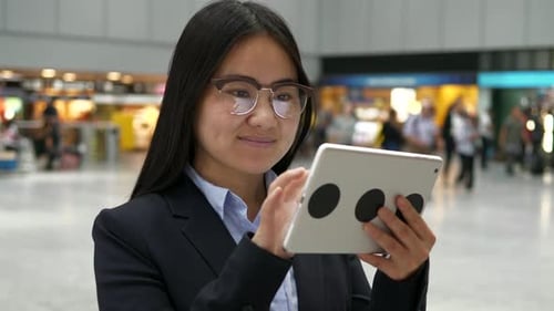Young Asian Businesswoman with Glasses Using Digital Tablet Screen