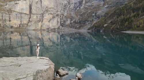 Woman Enjoying Scenic Mountain Lake Reflection