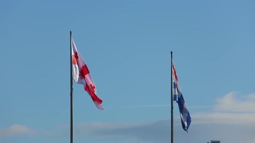 Flags Waving Against Blue Sky