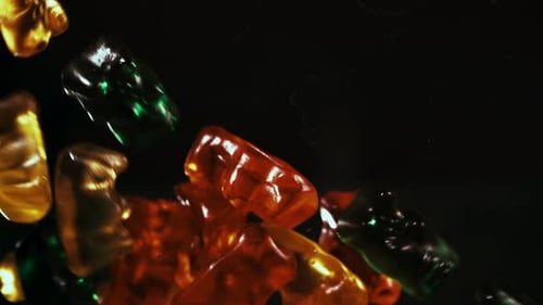 Gummy bears candies falling and floating in slow motion