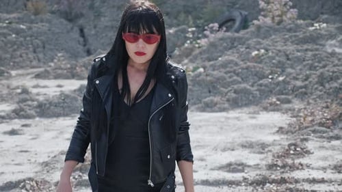 Stylish Woman Smoking in a Barren Desert Landscape