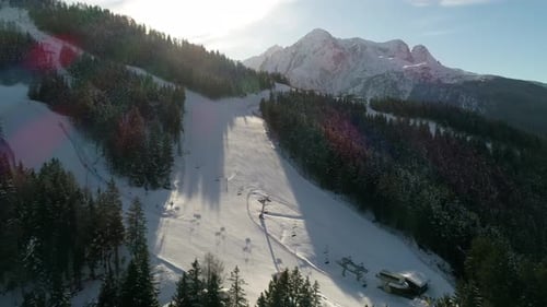 Picturesque high view over alpine ski trail in wintertime. Picturesque canopies of alpine trees. Win