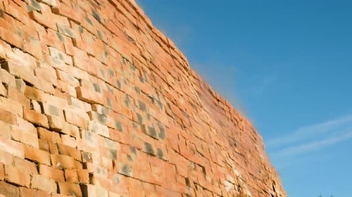 Heat and smoke escaping clamp kiln firing clay bricks; close-up against sky