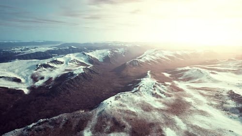 Large Snow Patch Left Over on the Volcanic Rock Field of a Mountain in Summer