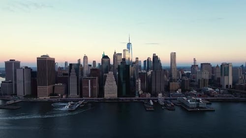 East river, Brooklyn bridge and the skyline of lower Manhattan, dawn in New York, USA - Aerial view