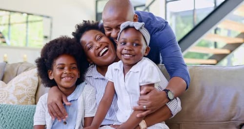 Happy Family Laughing and Smiling Together at Home