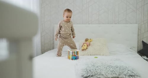 Baby Child Playing with Toys on the Bed in Bedroom Toddler Kid Having Fun at Home