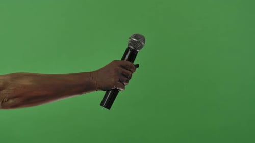 A Creepy Zombie Hand Holds a Microphone