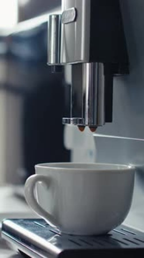Espresso machine pours coffee into mug
