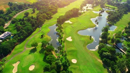 Drone flying over golf course in the morning with sunshine