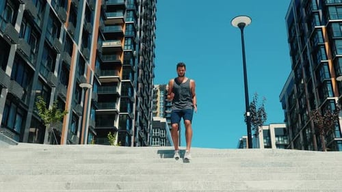 Athletic Man Runs Down Urban Concrete Steps