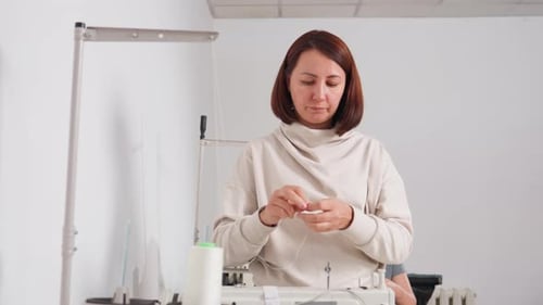 Fashion Designer Strengthening Thread On Sewing Machine With Concentration
