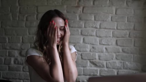Young Woman Working on Her Laptop Computer in Coffee Shop