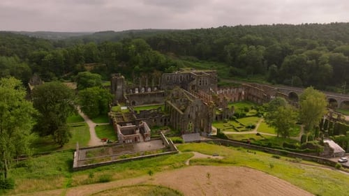 Aerial View of Villers Abbey a Ruined Cistercian Abbey in a Valley Tourists Walk the Grounds As the