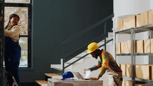 Team of Warehouse Employees Taking Boxes From Racks