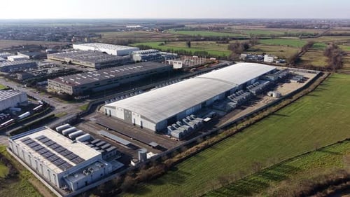 Aerial Drone View of Massive Industrial Warehouse Complex and Infrastructure