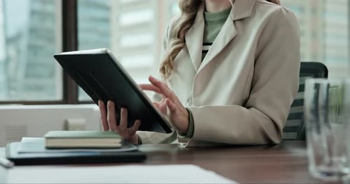 Woman Uses Tablet in City Office Setting