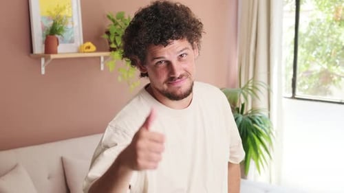 Smiling Young Adult Man Gives Thumbs Up