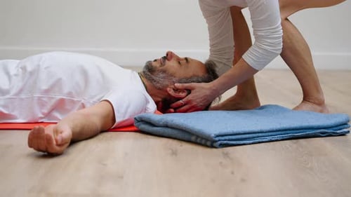 Man Receiving Head and Neck Massage Indoors