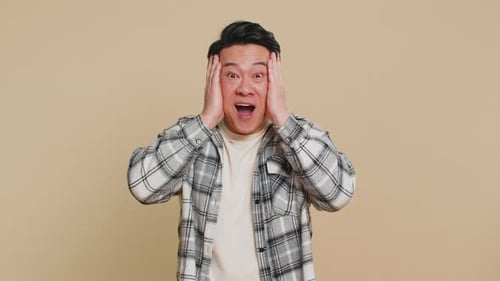 Man with Dark Hair Reacts with Excitement