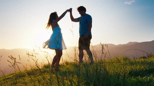 Couple Dance on the Green Hill at Sunrise