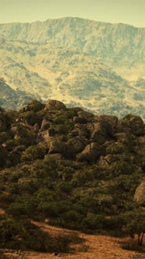A Majestic Mountain Range Framed By Lush Trees