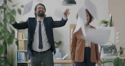 Loop Portrait of Joyful Businesspeople Man and Woman Throwing and Catching Documents and Laughing