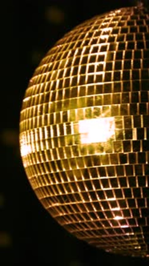 Elegant golden disco ball spinning. Vertical
