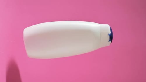 White Shampoo Bottle on Pink Background