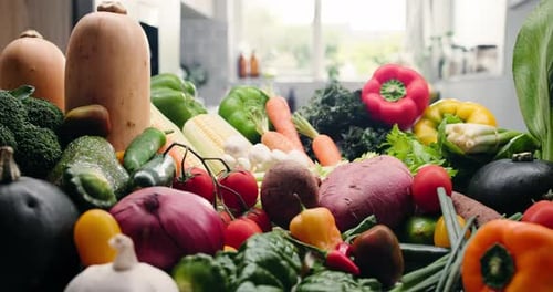 Assorted fresh vegetables and produce on kitchen counter