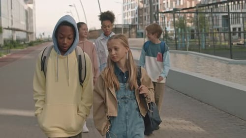 Multiracial Schoolkids Walking Together in City