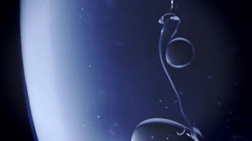 Oil is dripping into water, the drops are deforming and floating around. 240fps slowmotion