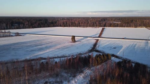 Winter Road Through Snow-Covered Rural Landscape
