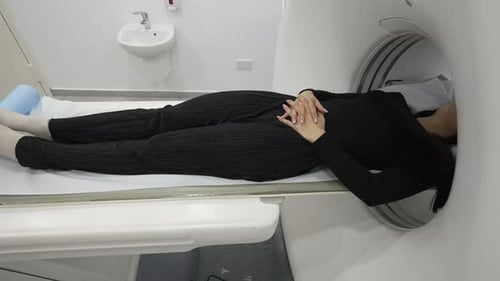 A female patient enters a CT for a computed tomography scan.