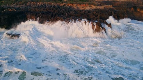 Drone View Rough Ocean Waves Crashing on Coastal Cliffs Sea Surf Lapping Beach