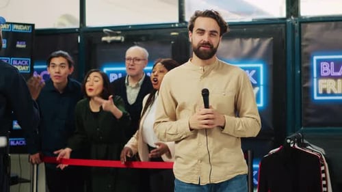 Man with Microphone Speaking at Black Friday Event