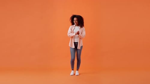 Smiling African American Woman Shows Thumbs Up in Room