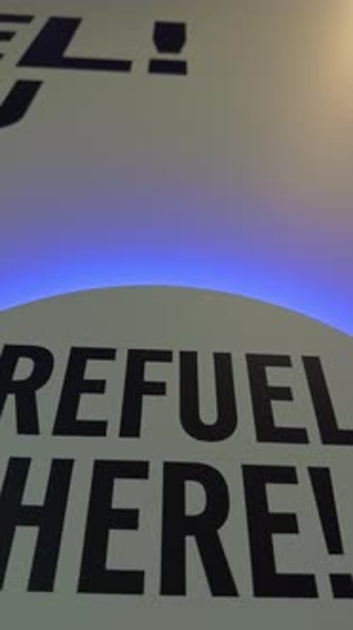 Refuel Here Signage with Blue Lighting