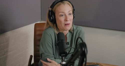 Podcaster in Studio Recording Business podcast, wearing Headphones
