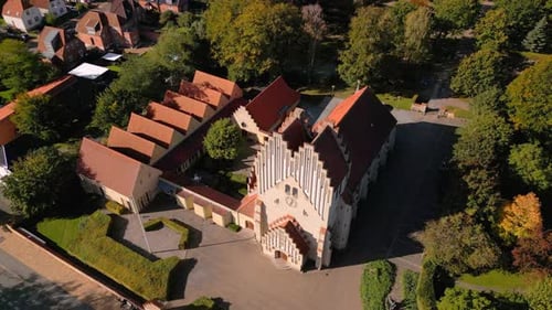Aerial shot of church in urban area on a sunny day
