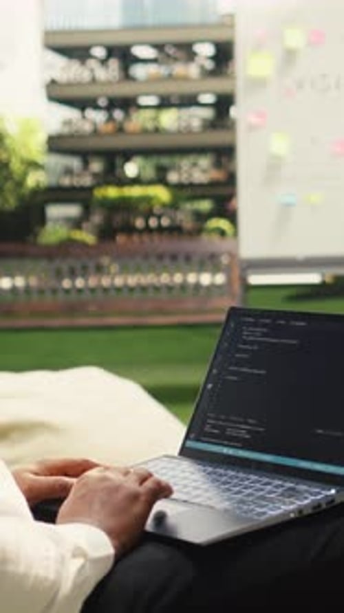 Vertical Video African American Businessman Coding on Laptop Terminal Window on Terrace