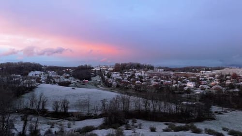 Aerial Sunset Over Leafless Forest to Morgantown, West Virginia with Snowy Fields