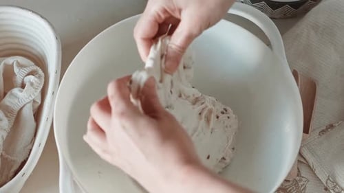 Hands Working Dough in a Bowl
