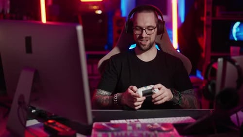 Young Man Playing Video Game with Controller and Headset