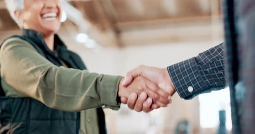 Engineering, teamwork or carpenter shaking hands in workshop for a manufacturing deal