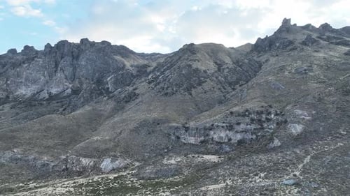 Ascending aerial reveal shot fly over over the landscape of Peru with a beautiful view of the mounta