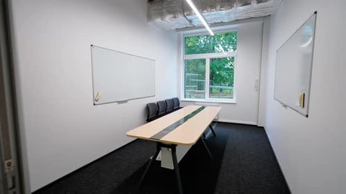 Empty Conference Room with Whiteboards and Long Table