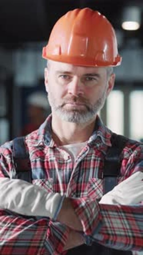 A Construction Worker Striving Hard in Safety Gear at a Busy Work Site That Inspires Focus